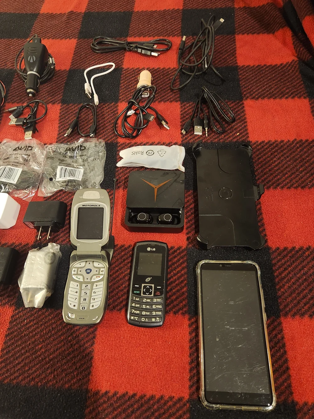 Elctronics Lot, Cellphones, Charging Cords, Remotes, And More